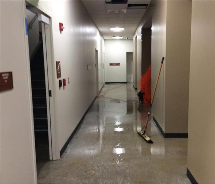Standing water in commercial hallway.