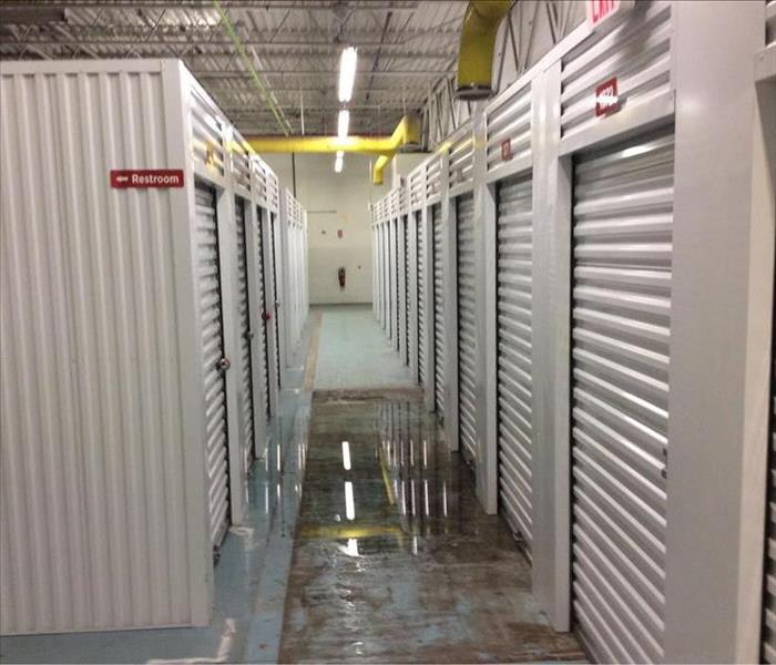 Storage facility with pool of water on ground.