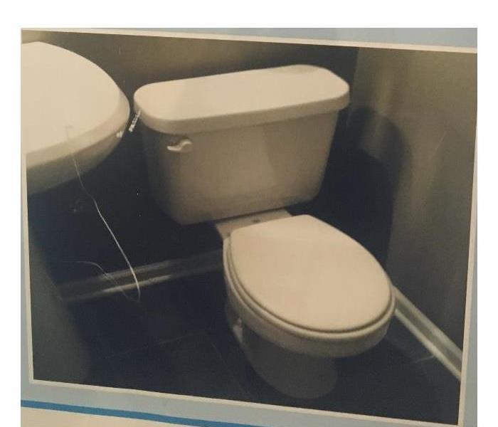 A clean toilet with the lid closed.