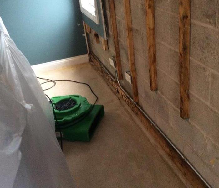 Removed dry wall and green drying equipment set up and running in a bedroom.