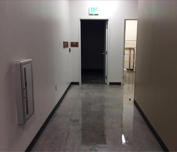 concrete hallway floor with water standing